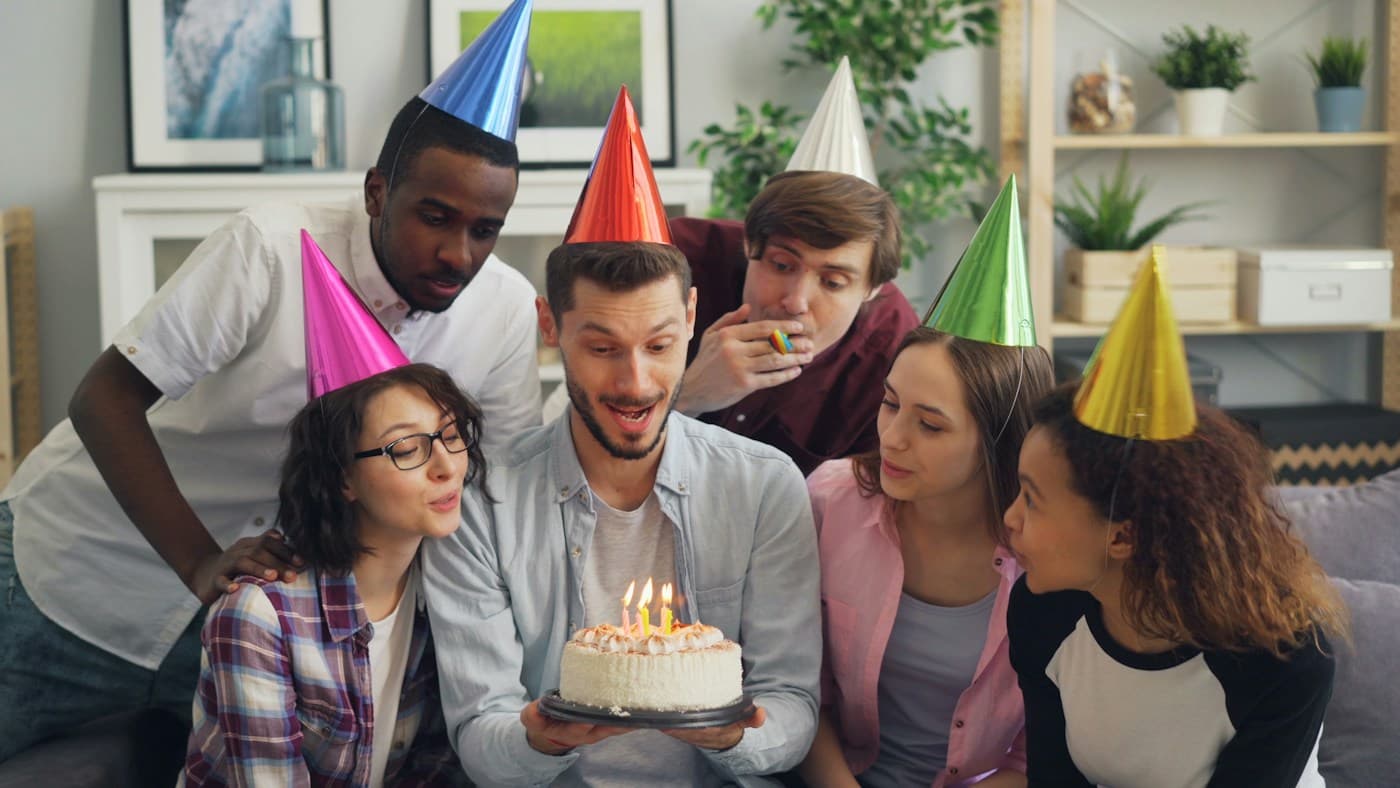 Friends gathered around a birthday cake